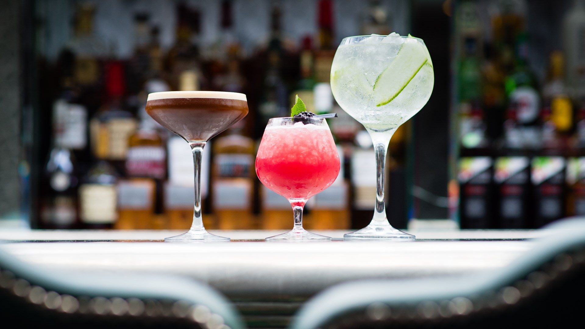 An esspresso martini, a frozen raspberry daiquiri and a Hendricks Gin and Tonic sitting on the bar