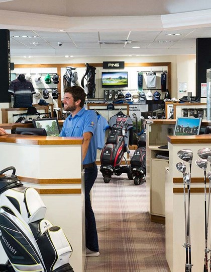 A golfer buying from the golf shop