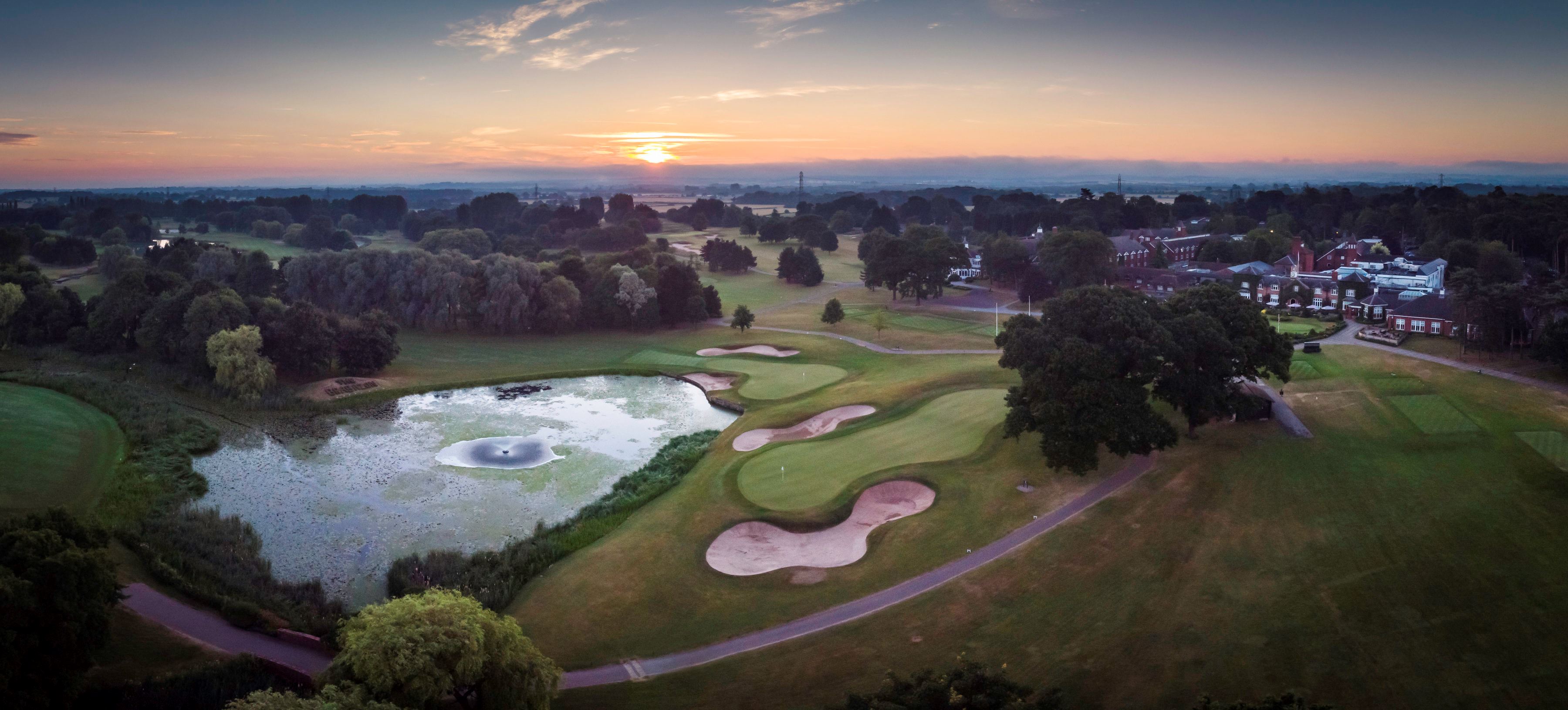 Birds eye view of golf course at sunset