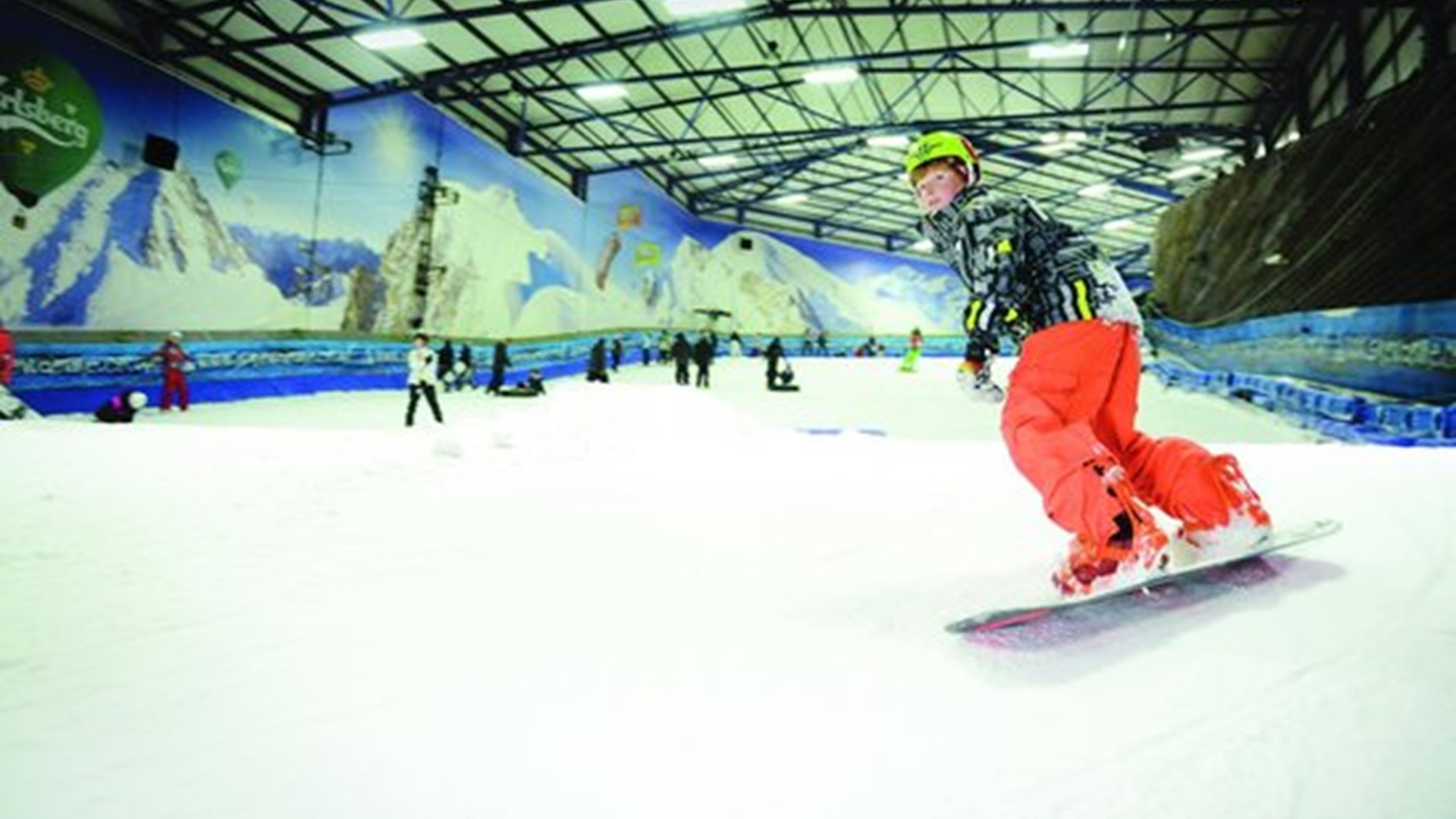 Snowborder going down hill at the snowdome