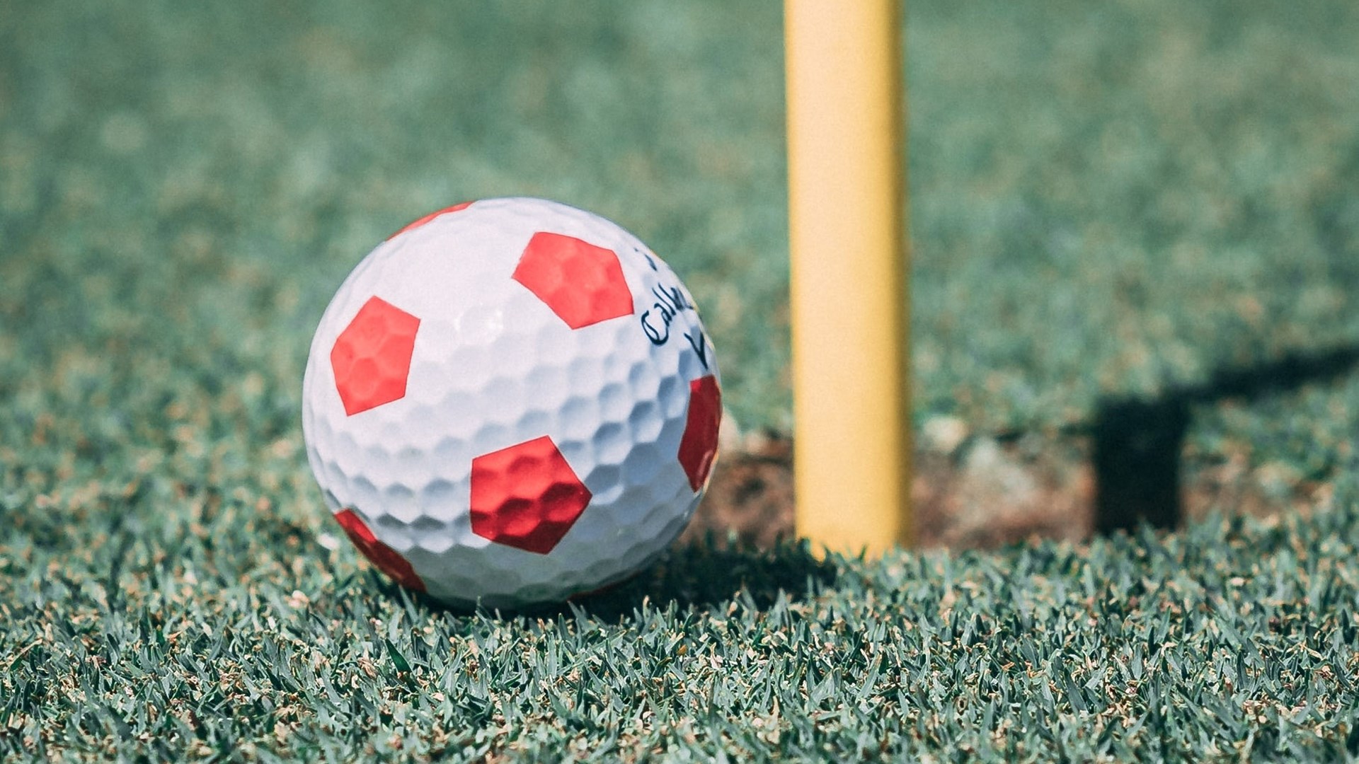 Close up of golf ball with football print